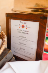 Menus and signage on the table at a wedding reception.